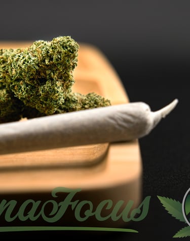 a marijuana leaf sitting on top of a wooden cutting board