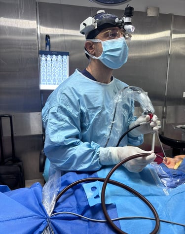 Surgeon performing endoscopic sinus surgery using specialized tools and a surgical headlamp.