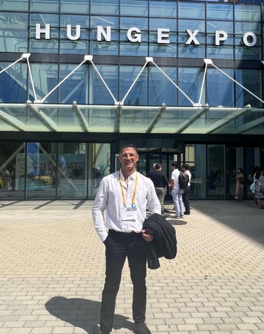 Professional attendee standing in front of the HUNGEXPO Budapest Congress and Exhibition Centre entrance.