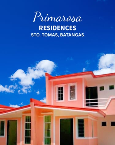 a pink house with a blue sky and clouds in the background