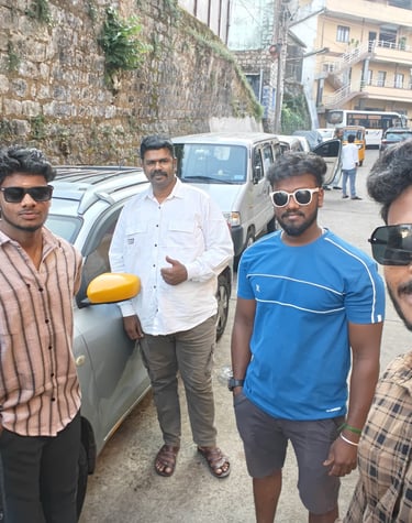 ​"Satisfied customers taking a group photo outside their South India Drop Taxi outstation cab during