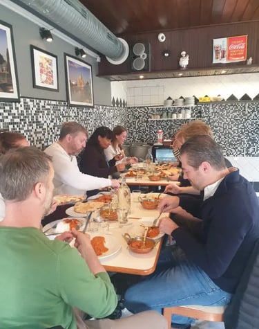 A group of friends dining together and enjoying authentic Indian cuisine at a local restaurant.