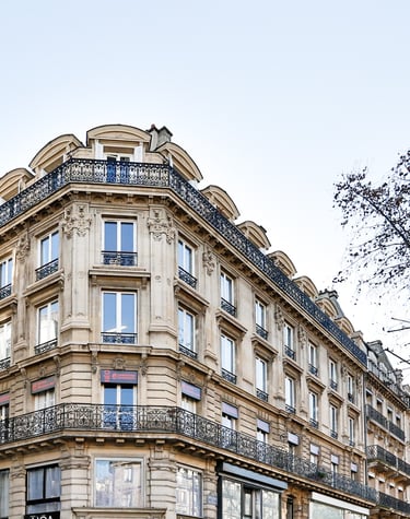a building with a clock tower in the middle of the street