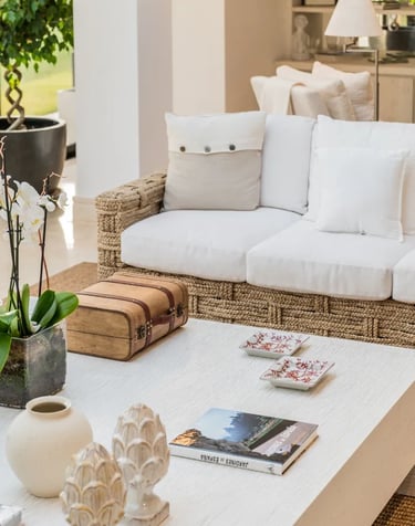 Natural-textured living area with woven sofa and garden views at Villa El Olivo, Marbella