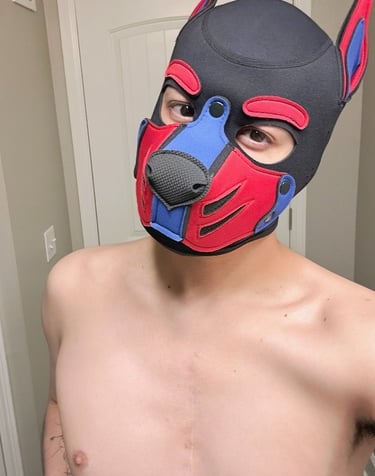 Man with bare chest in pup mask.