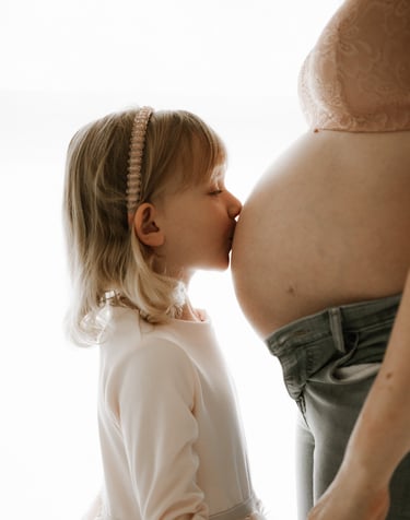 toddler kissing her mum's pregnant belly in studio - Littlehampton, Adelaide Hills