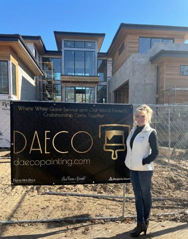 a woman standing in front of a sign that says daeco