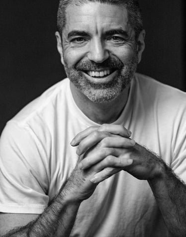 a man with a beard and a white shirt