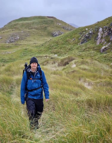 Martin Photography workshop tutor in grass carrying camera bag
