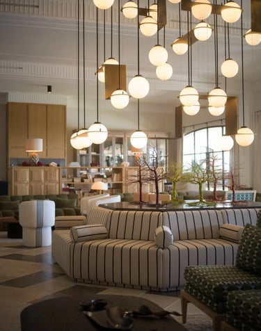 Main salon at Villa La Gratitud with sculptural lighting and striped circular sofa
