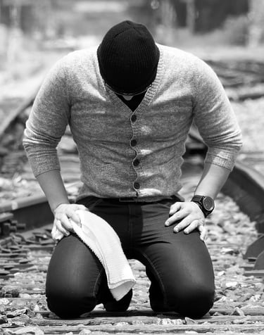 Homem ajoelhado, simbolizando compromisso com Deus e dedicação ao Instituto e à Comunidade Humana.