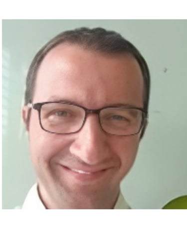 a man with glasses and a white shirt