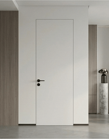 Modern white frameless hidden door with black handle in a minimalist interior design.