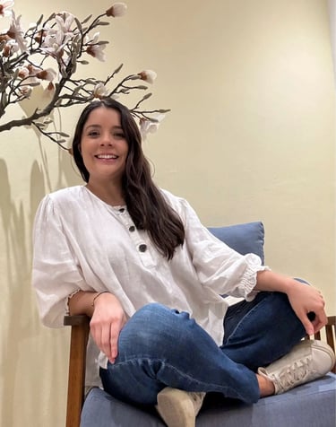 a woman sitting on a chair in a room
