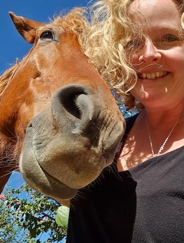 Sunni Dawson with a horse in a rural setting—reflecting intuitive connection