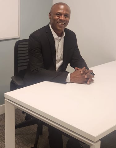 a man in a suit and tie sitting at a table