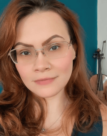 a woman with glasses and a blue tank top
