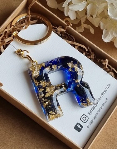 a keychain with a blue and gold foiled initial letter r