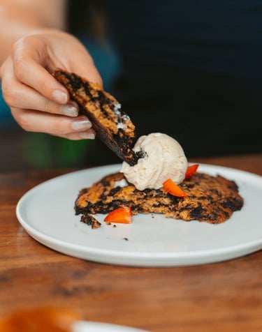 a person is eating a dessert on a plate