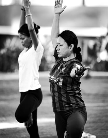Students practice the Tree Pose in a yoga class in Langkawi