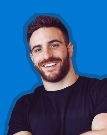 Professional Photo of Cory Blumenfeld, smiling and wearing a black T-shirt with a blue background