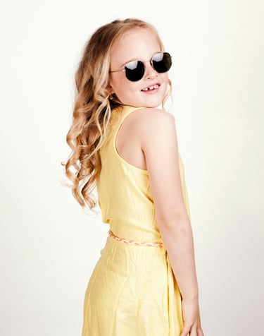 a young girl wearing sunglasses and sunglasses
