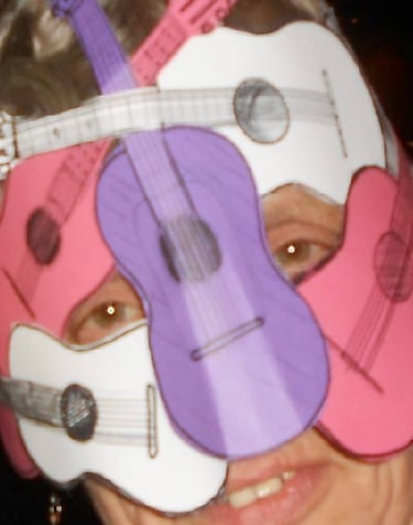 angi naylor with a guitar and a guitar in a mask