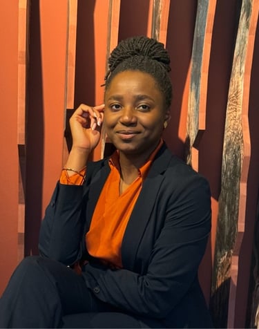 a woman in a suit and orange shirt