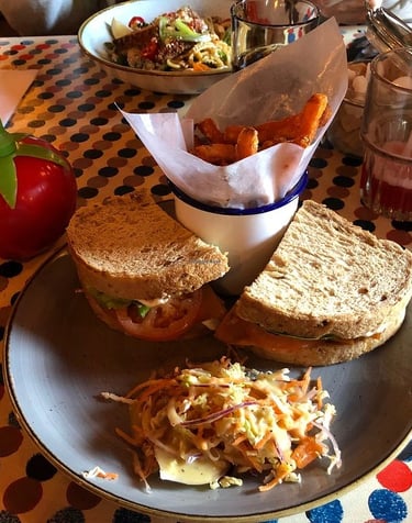 A sandwich with fries and a salad