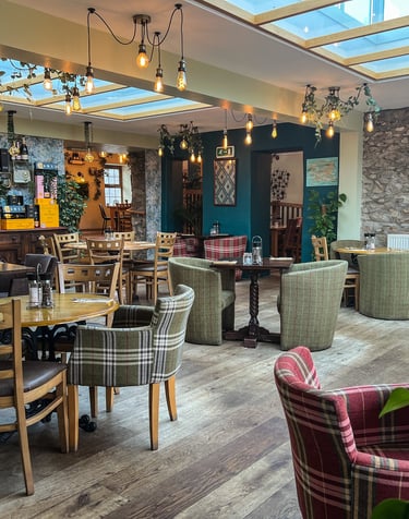 A restaurant with a skylight and tables and chairs