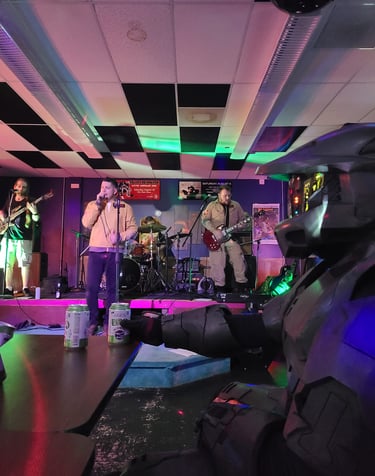 john and band on stage playing guitar