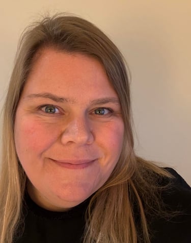 a woman with blonde hair and a black shirt