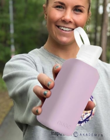 stiklo gertuvė moters rankose