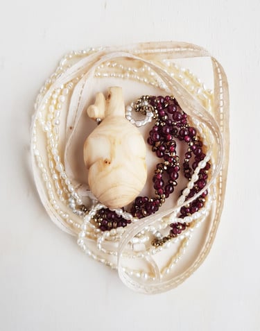 Wooden heart withe accompanied by granates, hematites, pearls, silver and antique lace. Wearable Art