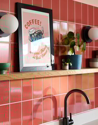 Glossy coral wall tiles with white grout in a modern kitchen splashback, featuring pastel pink