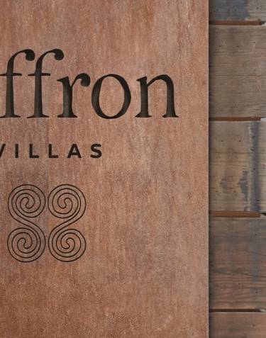 closup of Saffron Villas logo in wood