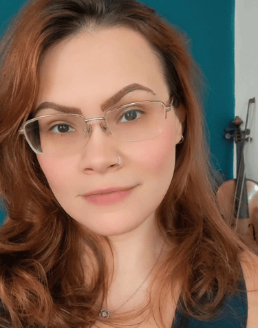 a woman with glasses and a blue tank top