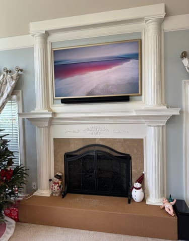a tv mounted over the fireplace wire free and modern