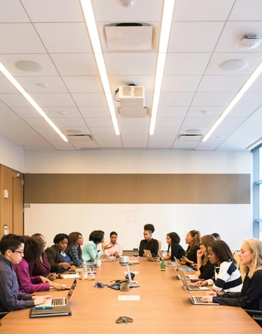 a group of people sitting around a table