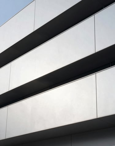 A minimalist and clean aesthetic photo of an architectural detail of a modern tech hub, with sharp angles and metallic surfaces, reflecting a professional and futuristic mood.