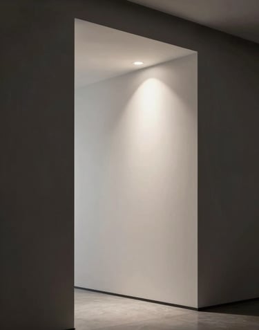 A vertical composition showing a modern, minimalist interior with clean lines and a single spotlight. The lighting creates deep shadows in dark charcoal and soft highlights in off-white, exuding a professional and sophisticated mood.
