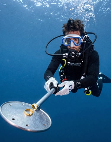 a man scubas in the water near a coral reef