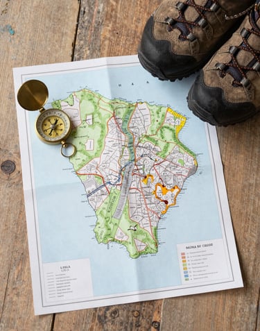 A top-down flat lay of a paper map of Yorkshire, a vintage compass, and a pair of hiking boots on a rustic wooden floor. Soft, natural mist white lighting.