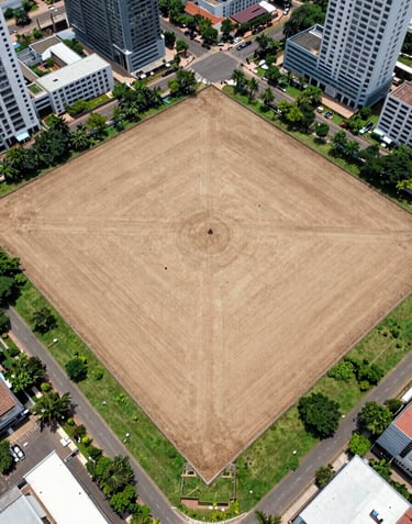 A high-angle drone photograph of a clean, level 1-acre land plot in Moulivakkam, surrounded by modern urban infrastructure and green patches.