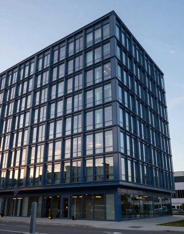 A sophisticated photograph of the port's modern administration building, featuring sleek glass and steel blue metal under a soft silver blue sky.