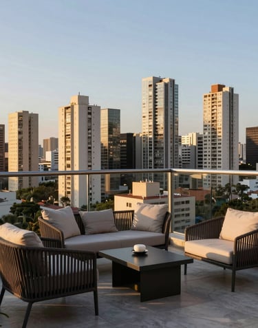 Breathtaking view from a high-floor balcony overlooking the São Paulo skyline during the golden hour. Luxury terrace with modern outdoor furniture.