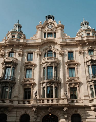 The historic facade of a classic building on Paseo de Gràcia in Barcelona, reflecting elegance and architectural sophistication under a clear blue sky.
