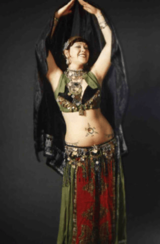Vintage Bellydancer Shahravar wearing traditional coin costume with red and green costume