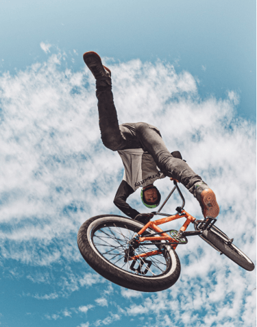 a man doing a trick on a bicycle