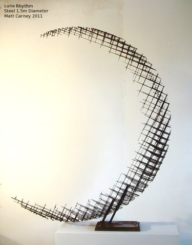 a rusted steel cross-hatched crescent shaped sculpture